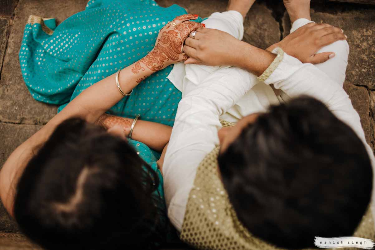 Bride and groom holding each others hand top angle at mukteswar temple bhubaneswar