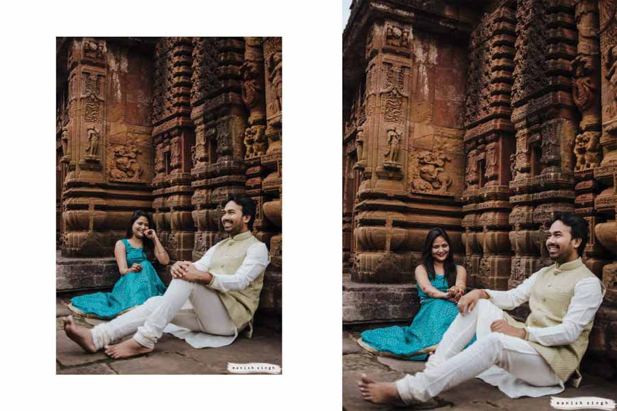 bride and groom smiling while sitting next to temple wall at mukteswar temple bhubaneswar