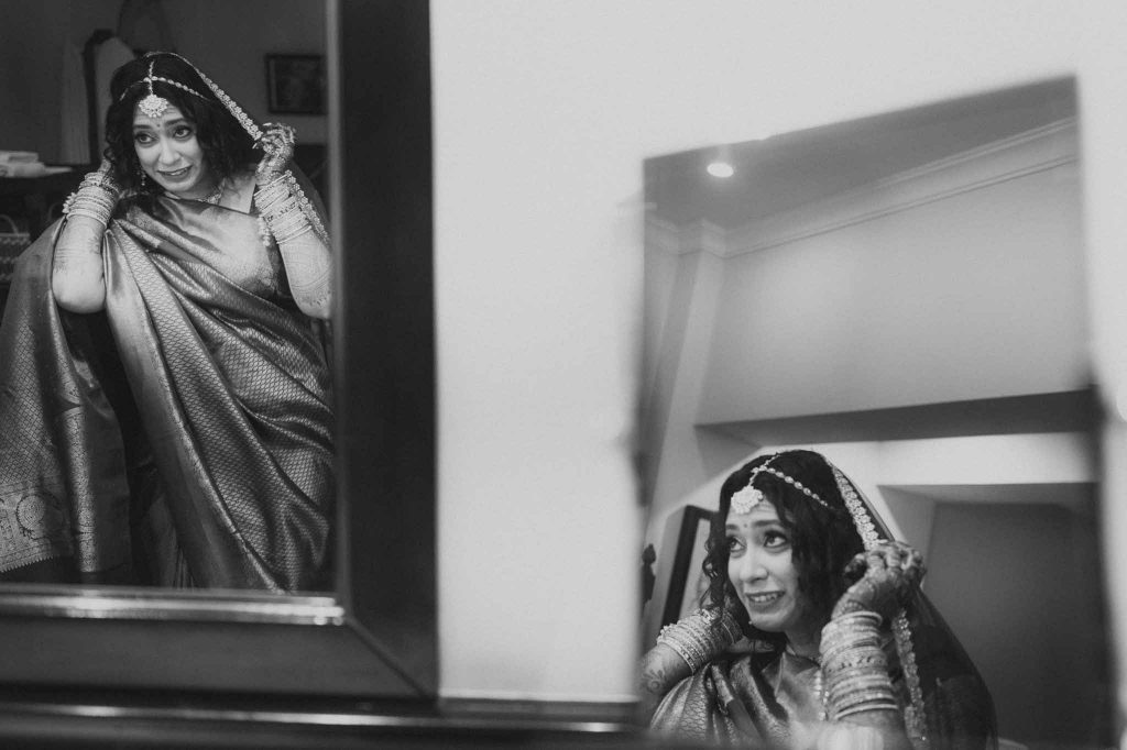 bride getting ready in front of mirror