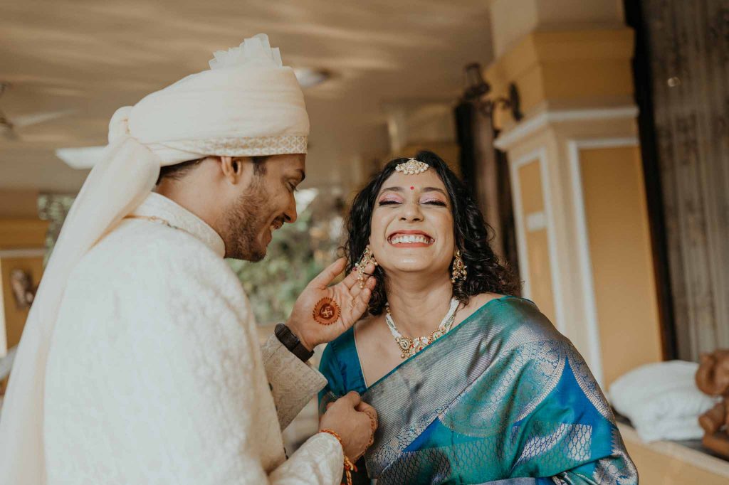 bride shows earring to groom on her wedding day