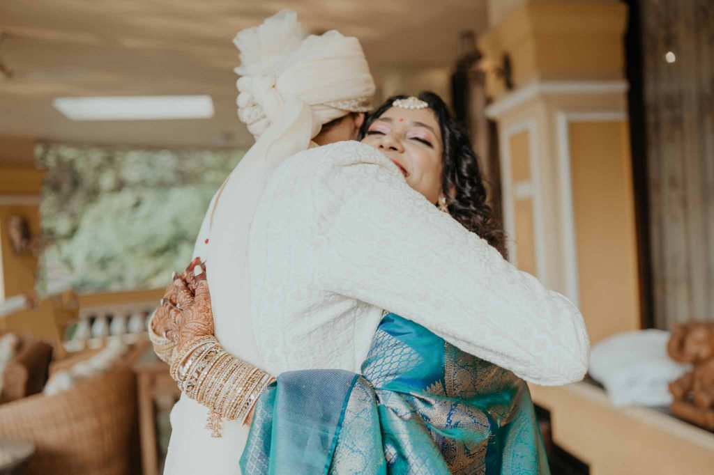 groom hugs bride on seeing her in front of lake view Mayfair lagoon Bhubaneswar