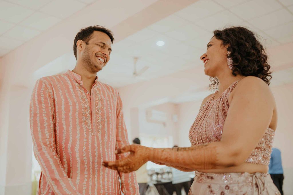 bride and groom candid smile in mehendi ceremony