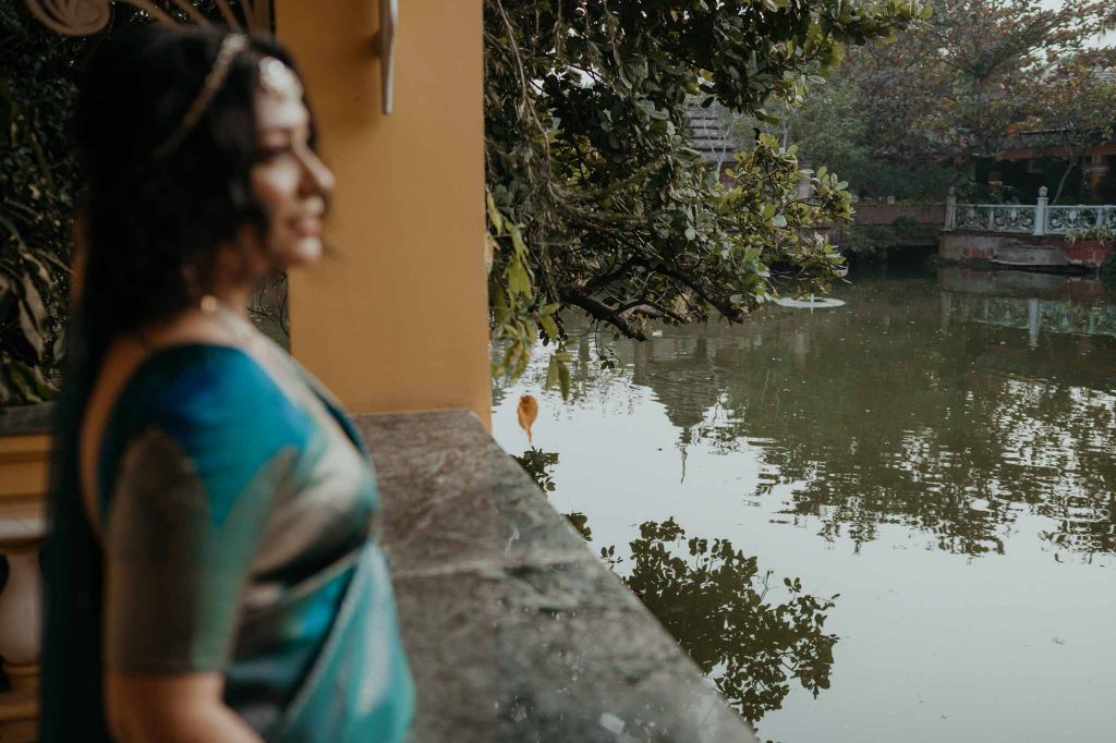 bride looking towards lake in Mayfair lagoon Bhubaneswar