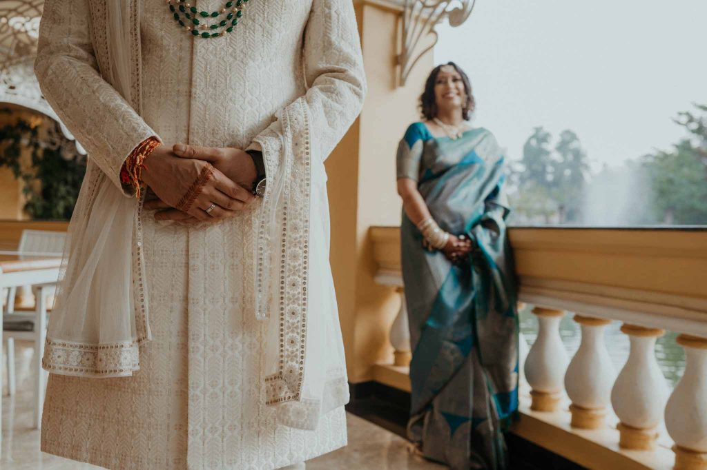 bride looking towards groom in balcony of room in Mayfair lagoon Bhubaneswar