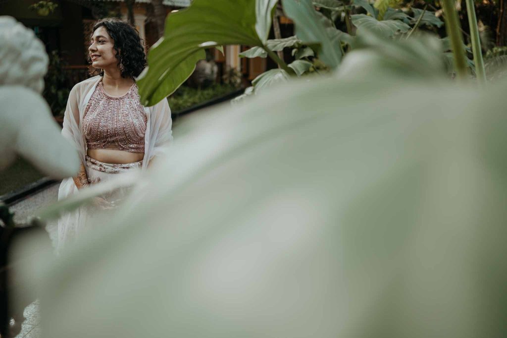 bride minimal portrait with leaves in front in Mayfair lagoon bhubaneswar